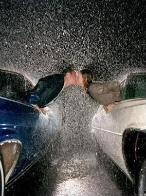 romantic couple kissing in rain. house young couple kissing in